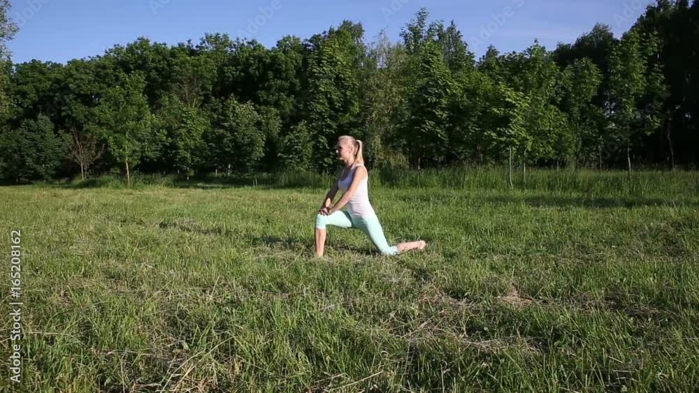 Beautiful blonde woman engaged in fitness in the park Beautiful blonde woman engaged in fitness in the park