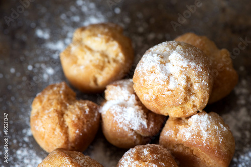 Homemade small donuts with powdered sugar