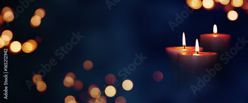 Candle lights in the darkness photo