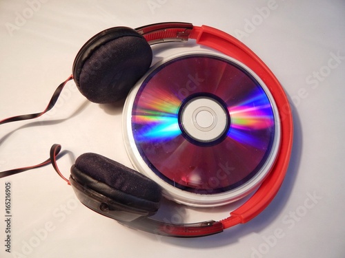 Colorful Music CD Disc And Earphones On White Background 