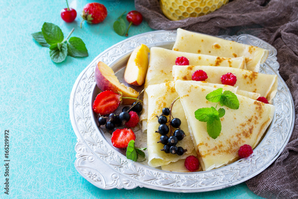 Pancake breakfast with honey and fresh berries of currants, strawberries, nectarines, sweet cherries and raspberries. Pancake breakfast with honey and fresh berries of currants, strawberries, nectarines, sweet cherries and raspberries.