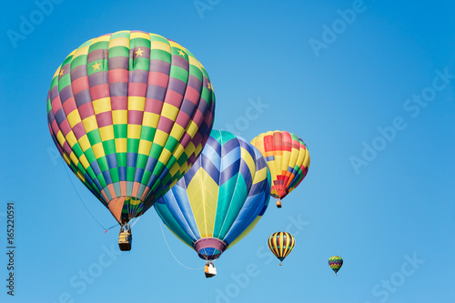 Multi colored hot air balloons in bright morning sky