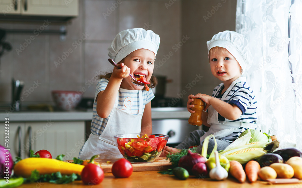Healthy eating. Happy children prepares vegetable salad in kitchen. Healthy eating. Happy children prepares vegetable salad in kitchen.