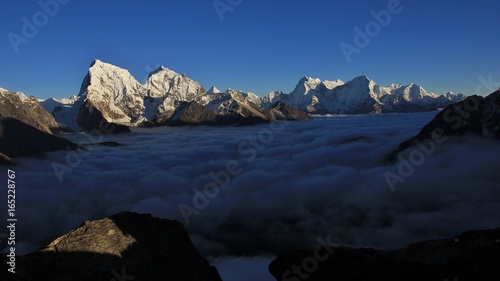 High mountains in the Everest National Park reaching out of clouds. Autumn scene in the Gokyo valley, Nepal.