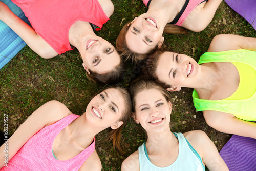 Group of young women lying ...