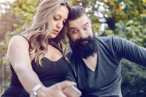 modern attractive couple making selfie