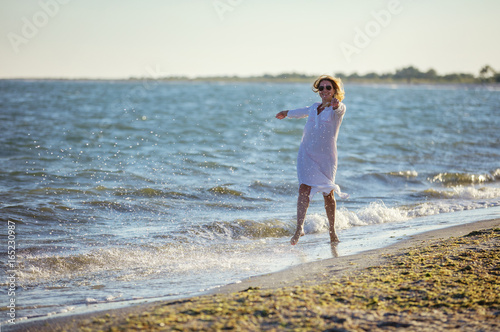 Young woman having fun on beach © Andrey Bandurenko