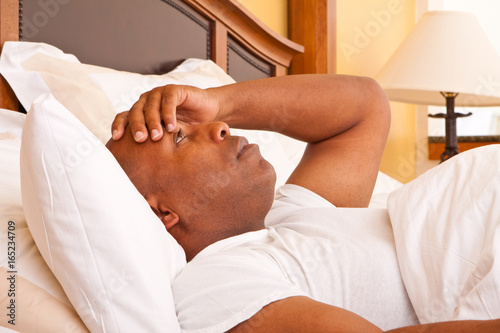 African American man having trouble sleeping.