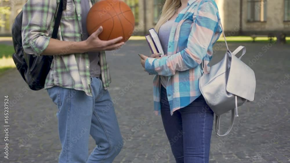 Young athletic man flirting with smart girl near university, students, meeting Young athletic man flirting with smart girl near university, students, meeting