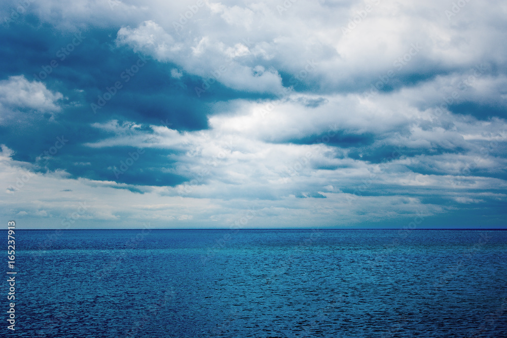 Dark clouds over the water of the sea. Summer.