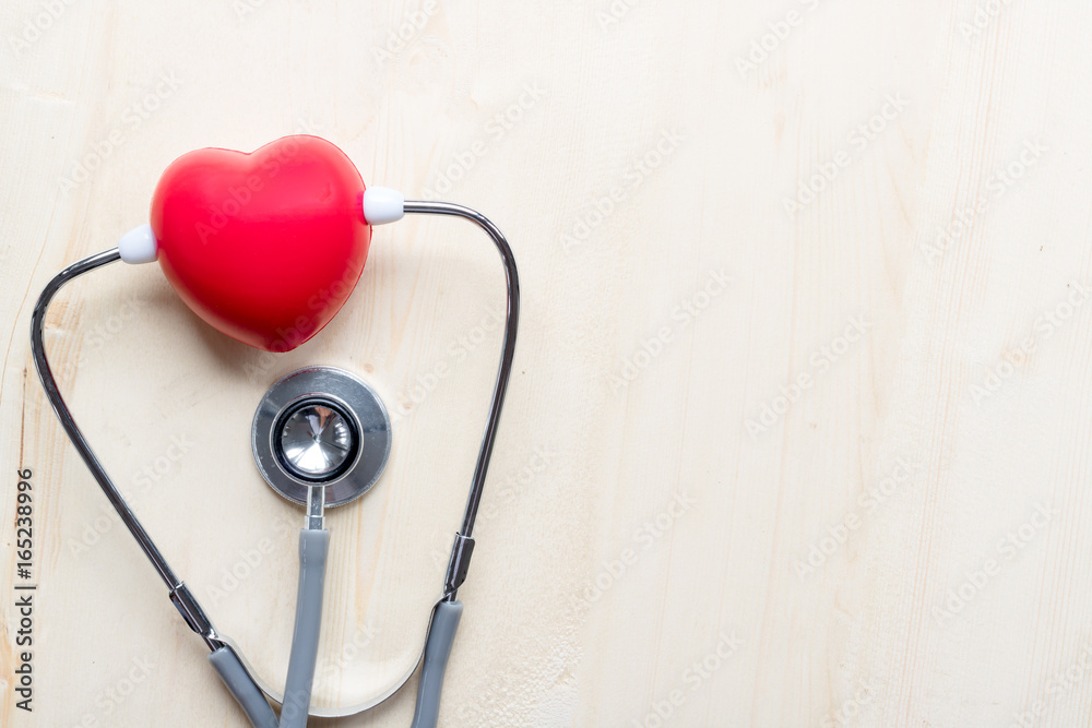 pillow heart and Stethoscope on wood table with health care concept pillow heart and Stethoscope on wood table with health care concept