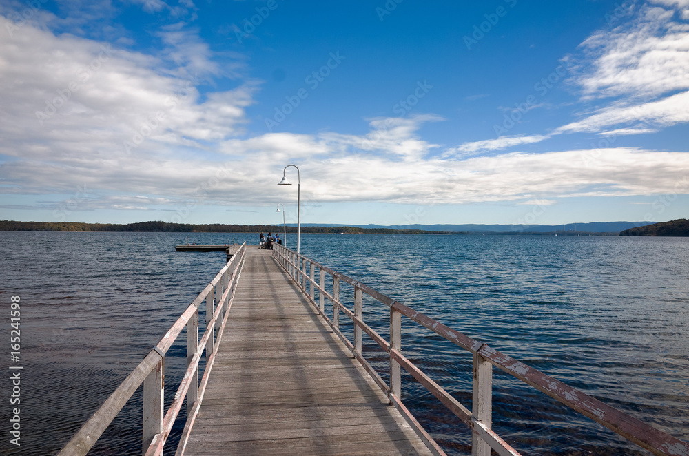 Anglers fishing from long Wooden Jetty on Lake Macquarie Australia