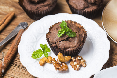 Chocolate cupcakes with mint on wooden table