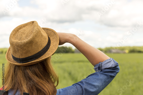 Woman in hat looking over meadow, outdoor activity, hiking © artursfoto