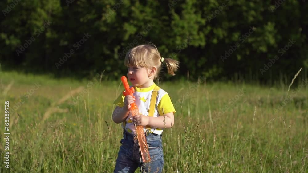 Little girl blowing bubbles in the park. Little girl blowing bubbles in the park.