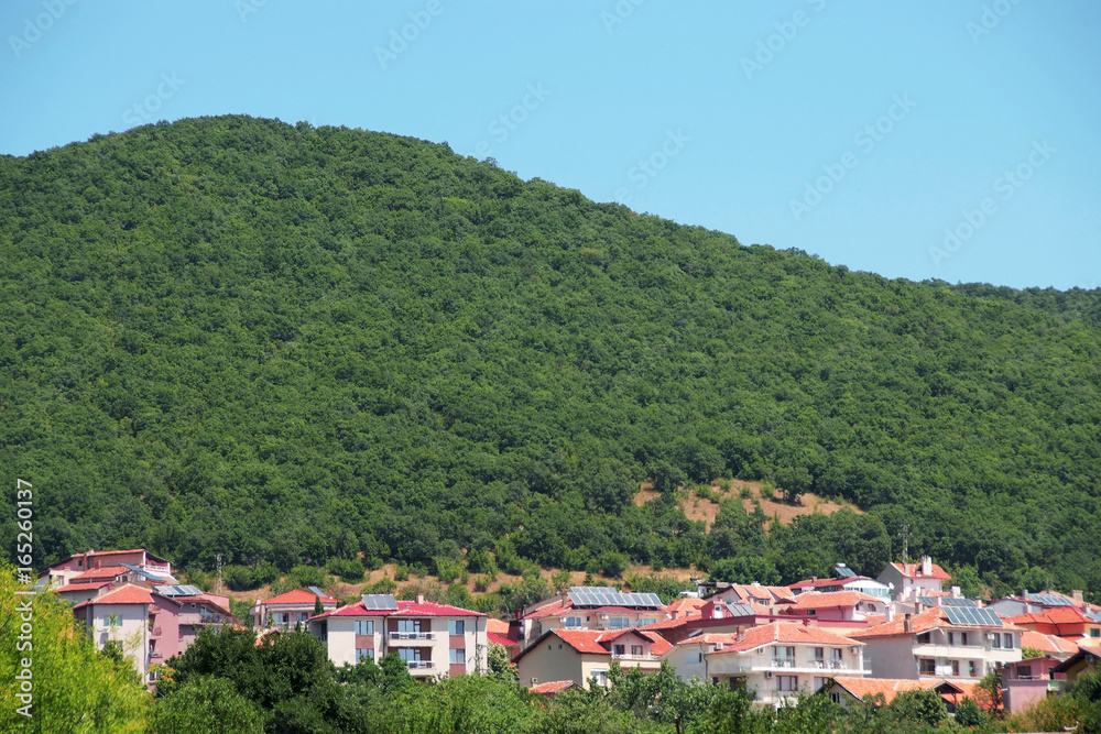 Panorama of the beautiful houses and red roofs of the Balkan mountains nature Bulgaria summer resort