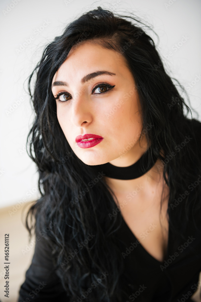 Portrait of young turkish brunette woman wearing in black on white background Portrait of young turkish brunette woman wearing in black on white background