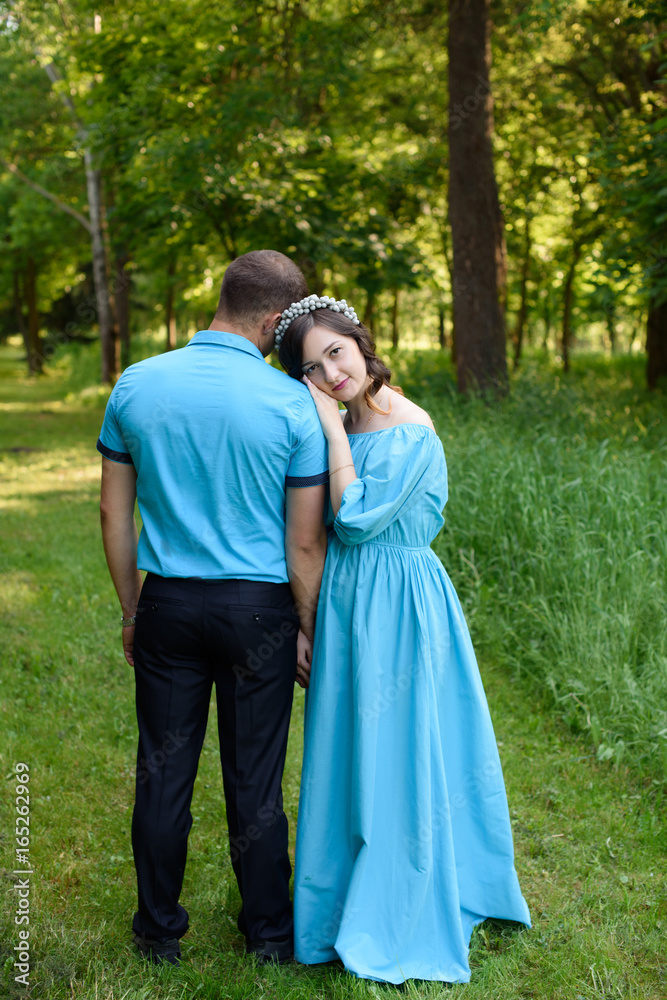 Fototapeta premium Pregnant couple posing in the park