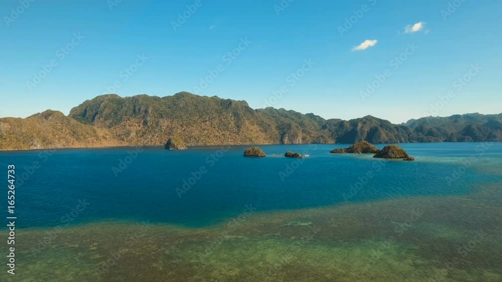 Aerial view: beach, tropical island, sea bay and lagoon, mountains with rainforest, Palawan. Lagoon with blue, azure water in the middle of small islands and rocks. Busuanga. Seascape, tropical Aerial view: beach, tropical island, sea bay and lagoon, mountains with rainforest, Palawan. Lagoon with blue, azure water in the middle of small islands and rocks. Busuanga. Seascape, tropical