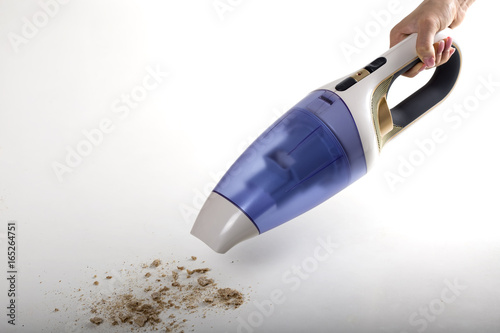 Cleaning bread crumbs with a portable vacuum cleaner photo