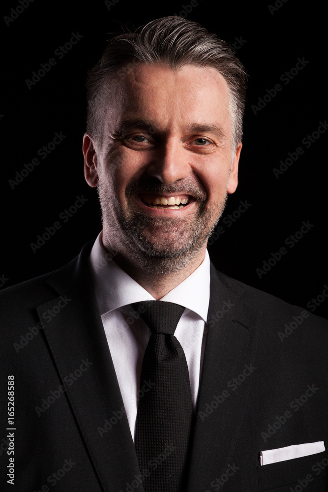 Portrait of adult confident businessman in studio photo on black background Portrait of adult confident businessman in studio photo on black background