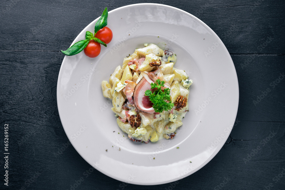 Potato dumplings with meat and vegetables. On a wooden background. Top view. Free space for text. Potato dumplings with meat and vegetables. On a wooden background. Top view. Free space for text.
