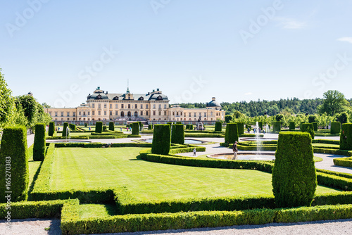 View over Drottningholm Palace and park on a sunny summer day. Home residence of Swedish royal family. Famous landmark and tourist destination in Stockholm, Sweden