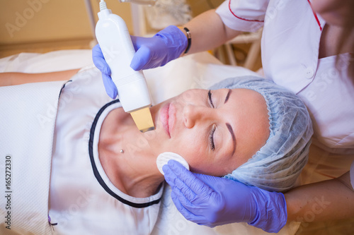 Cosmetology doctor makes facial procedures