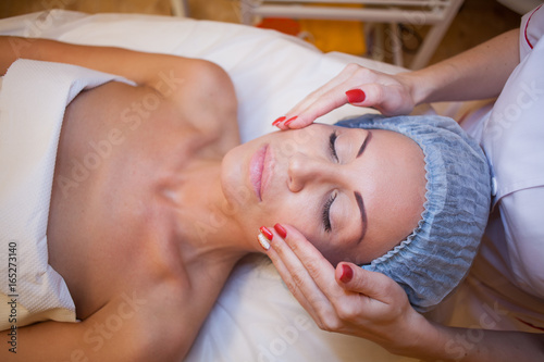 Cosmetology doctor makes facial procedures photo