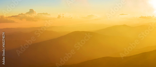 Fairytale panorama of mountain ranges in the twilight and clouds, pastel colors