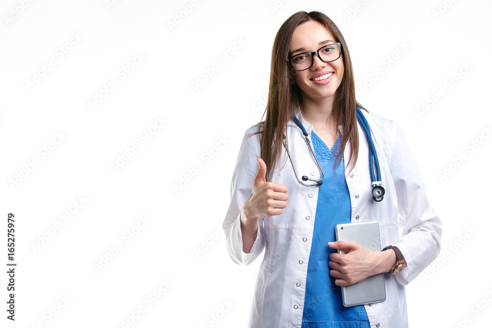 Portrait of a young attractive doctor woman showing Ok sign, standing in white lab coat isolated background with the tablet Portrait of a young attractive doctor woman showing Ok sign, standing in white lab coat isolated background with the tablet