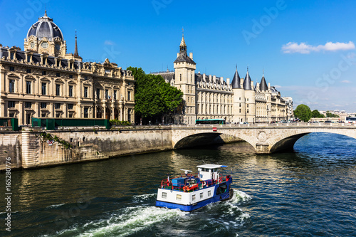 Conciergerie Castle and Seine River with cruise tour boat. Paris, France