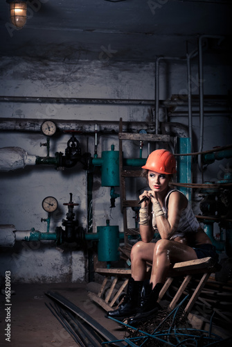 Beautiful girl wearing a helmet in the boiler room