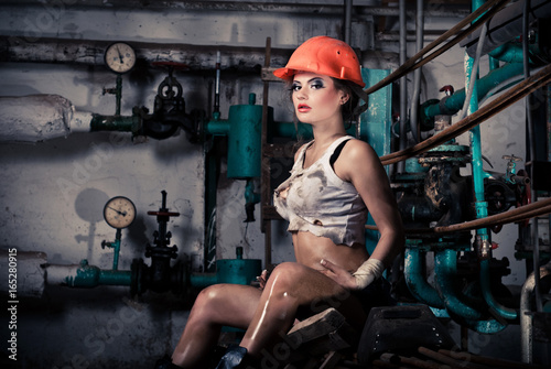 Beautiful girl wearing a helmet in the boiler room
