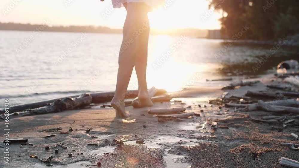 Legs of beauty girl walking barefoot along wet sand beach over sunset. Bare feet of young woman walking on beach beside ocean. Slowmotion video footage. Full HD 1920x1080p. Legs of beauty girl walking barefoot along wet sand beach over sunset. Bare feet of young woman walking on beach beside ocean. Slowmotion video footage. Full HD 1920x1080p.