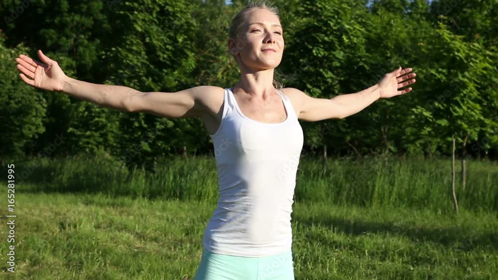 Beautiful blonde woman engaged in fitness in the park Beautiful blonde woman engaged in fitness in the park