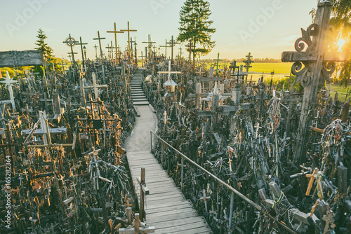 Hill of crosses (Kryziu kalnas), pilgrimage site in northern Lithuania, summer sunset time photo