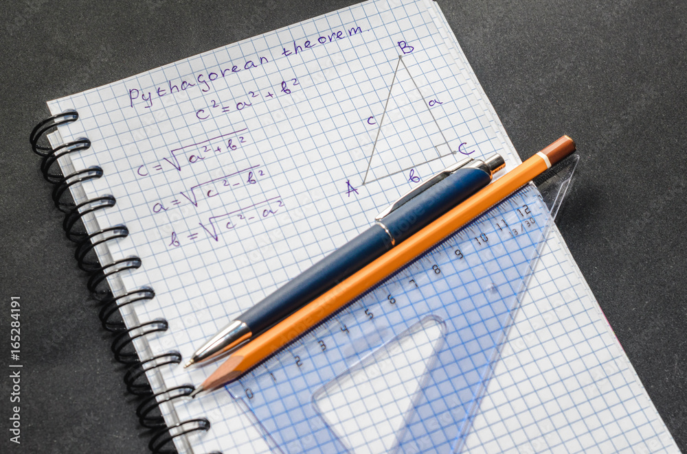 Page with formulas and the Pythagorean theorem with pen and pencil Page with formulas and the Pythagorean theorem with pen and pencil