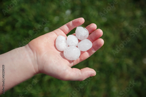 Large hail on the child's palm after summer hailstorm in Vienna, Austria.