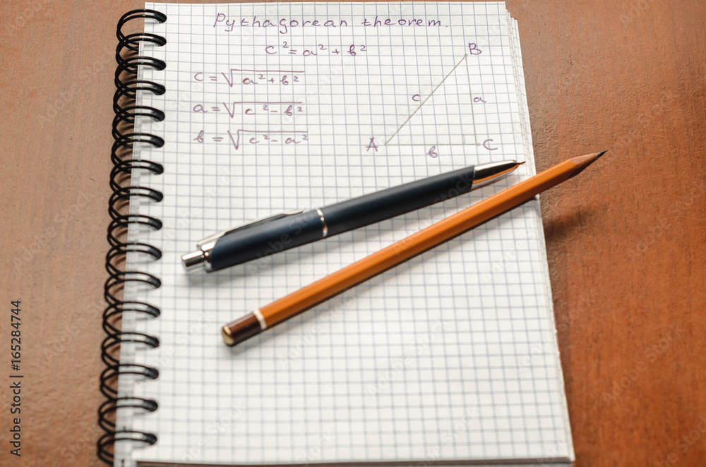 Page with formulas and the Pythagorean theorem with pen and pencil Page with formulas and the Pythagorean theorem with pen and pencil