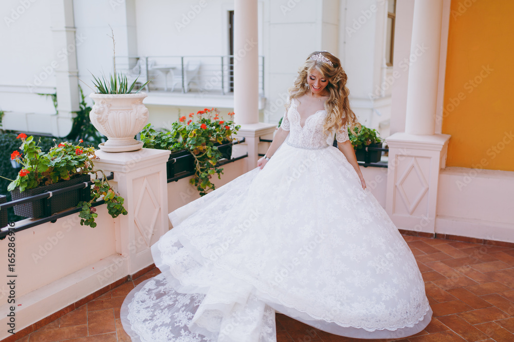 Beautiful curly blonde bride with a bouquet of flowers Beautiful curly blonde bride with a bouquet of flowers