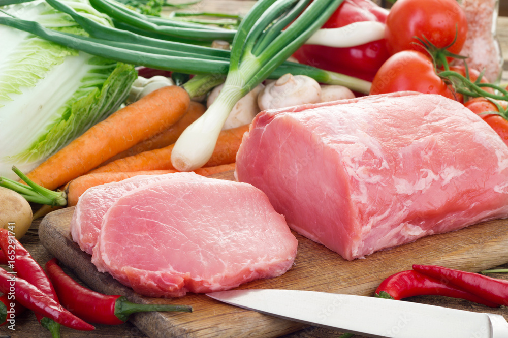 Fresh meat and vegetables on kitchen board Fresh meat and vegetables on kitchen board