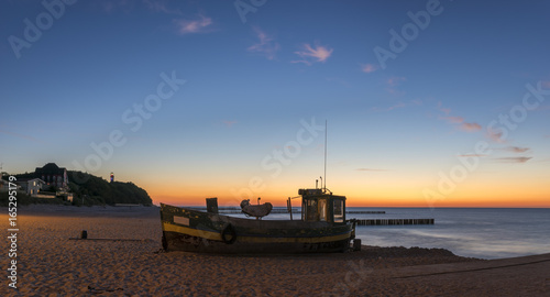 Fishing boat on the beach in the evening