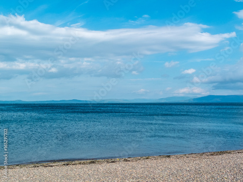 Peble beach blue sea hills and blue sky. photo