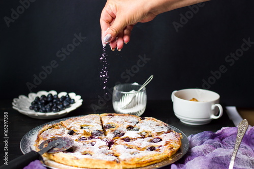 Female adding sugar to a sweet pie © creativefamily