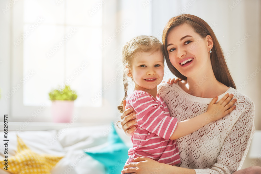 Mother and daughter playing and hugging