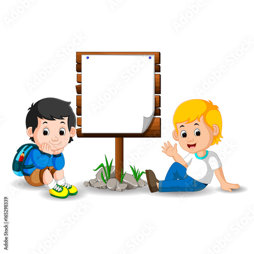 Wooden sign on colorful park with children photo