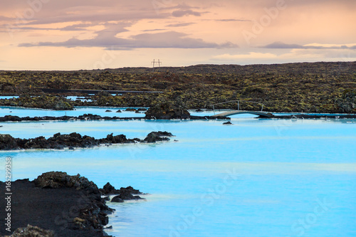Blue lagoon waters in the lava field landscape of Iceland in winter