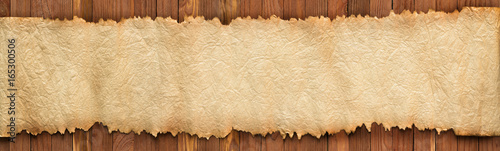 Open ancient scroll on a wo...