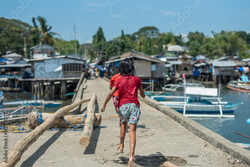 Kids running away on the pier © Viktor